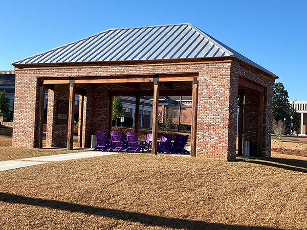 Purple Adirondack chairs placed inside the Barrs Family Learning Pavilion on the Cochran Campus.